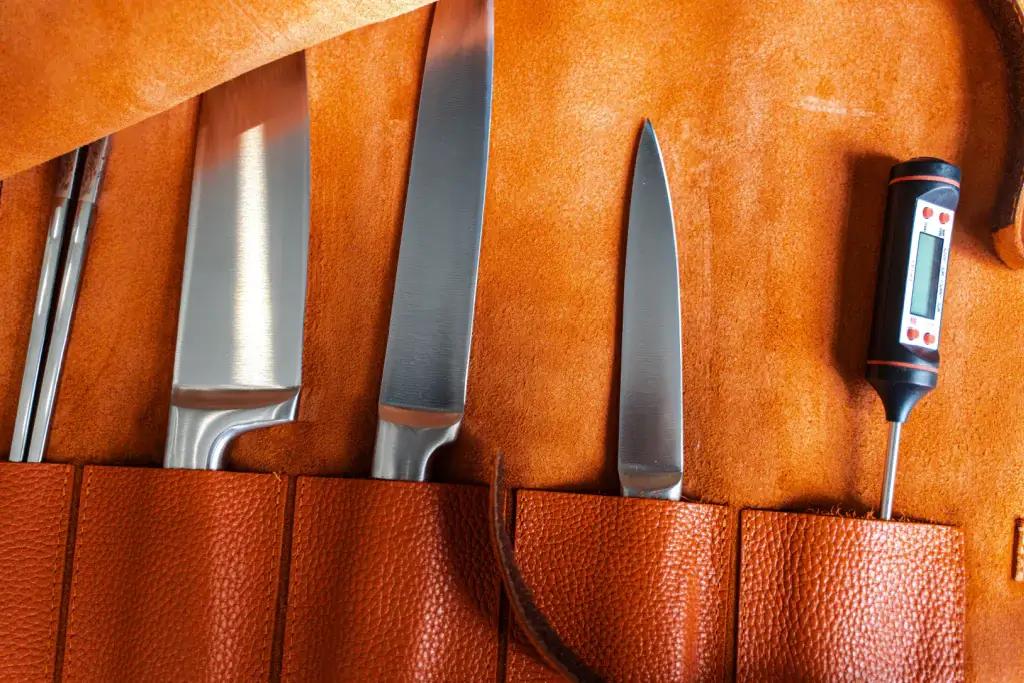 A bunch of knives in a leather knife roll, a perfect example of knife storage.