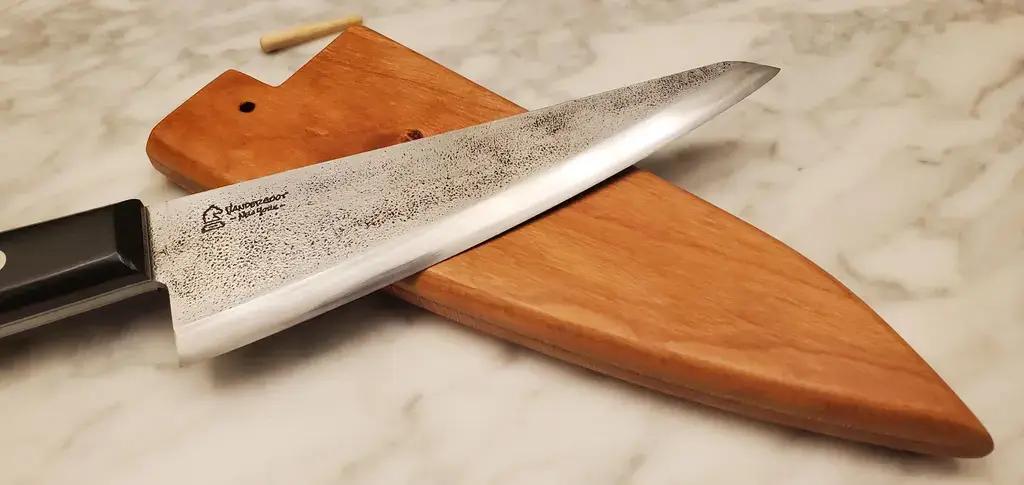 A honesuki knife near its sheath.