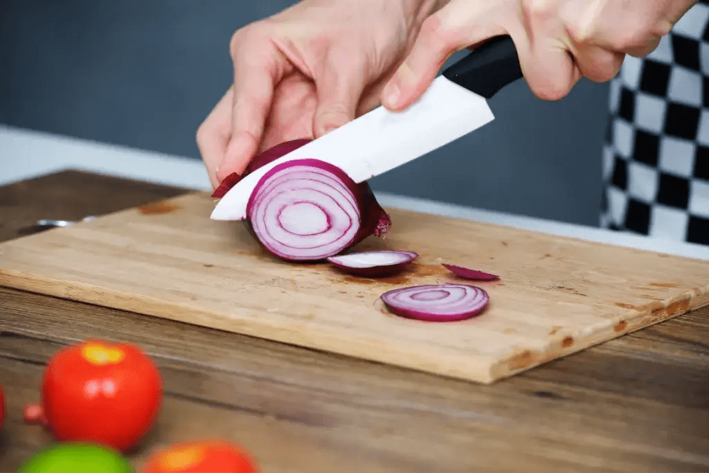 Someone chopping onions with a ceramic blade.