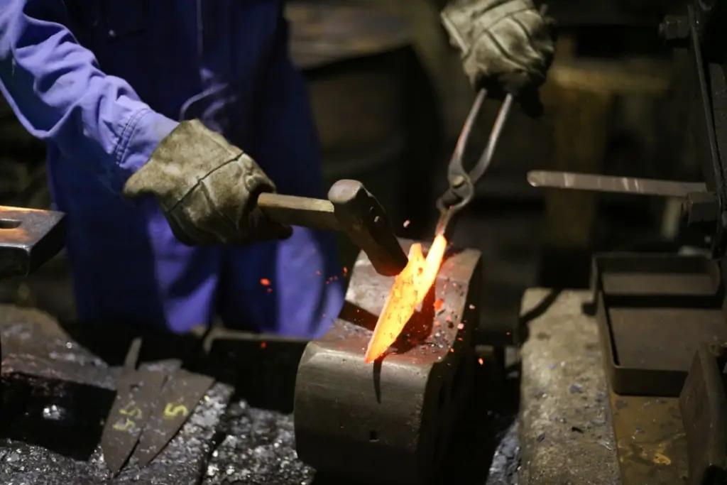 A blacksmith making a Japanese knife.
